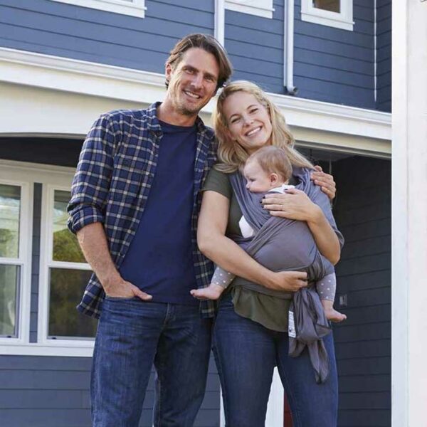 Happy family with baby outside home